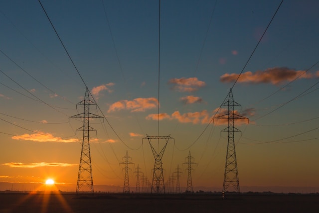 High-voltage transmission towers at sunset